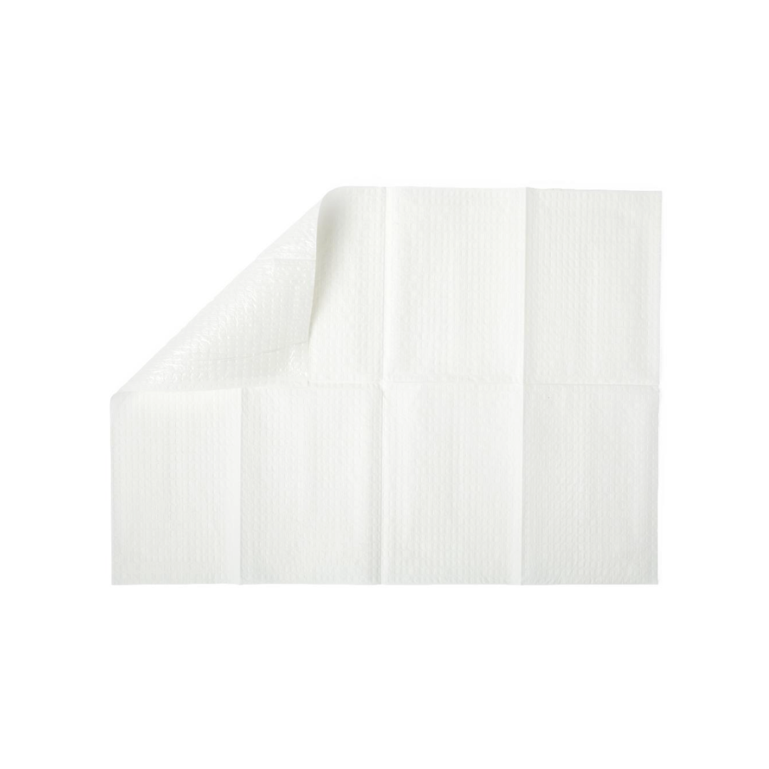 A white disposable underpad with a quilted pattern, partially folded at one corner, is shown on a plain white background next to Medline 2-Ply Tissue/Poly Professional Towels.